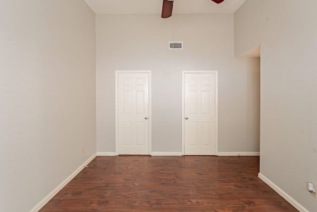 12626 Lacey Crest Dr, Houston, TX 77070 - unfurnished room with a high ceiling, dark wood-style floors, visible vents, a ceiling fan, and baseboards
