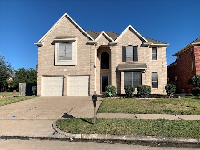 view of front of home with brick siding, an attached garage, a front lawn, and concrete driveway