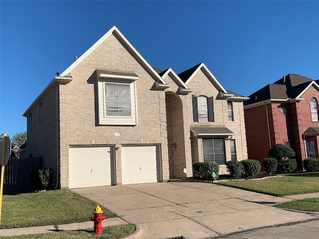traditional home with brick siding, an attached garage, and concrete driveway