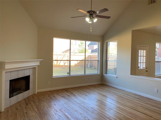 unfurnished living room featuring wood finished floors, visible vents, a ceiling fan, and baseboards