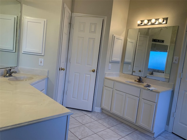 bathroom with two vanities, tile patterned flooring, and a sink