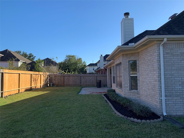 view of yard with a fenced backyard and a patio area