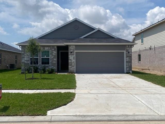 1425 17th Ave N, Texas City, TX 77590 - ranch-style house featuring an attached garage, a front lawn, concrete driveway, and stone siding