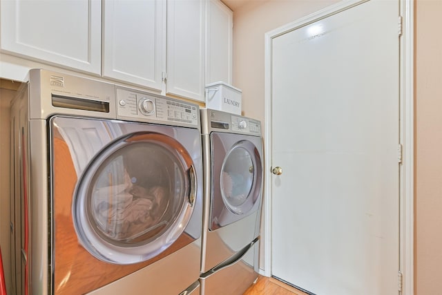 laundry area with cabinet space and independent washer and dryer