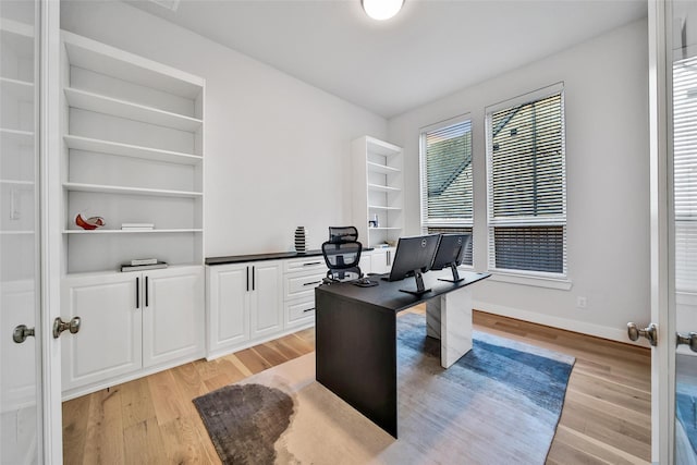 office with baseboards and light wood-style floors