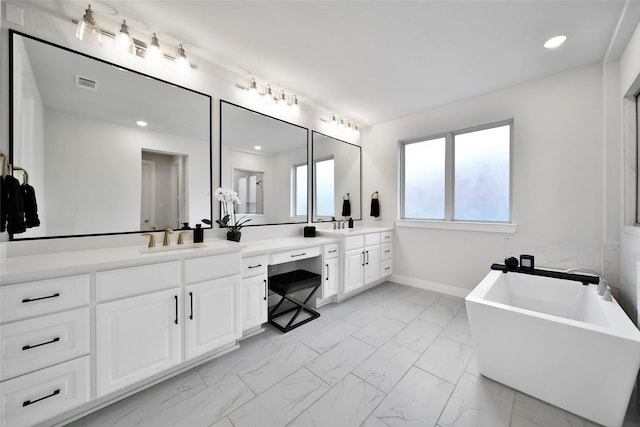 full bathroom featuring vanity, marble finish floor, recessed lighting, visible vents, and a soaking tub