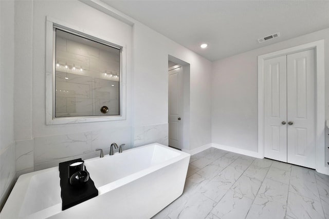 bathroom with marble finish floor, recessed lighting, a freestanding tub, visible vents, and a stall shower