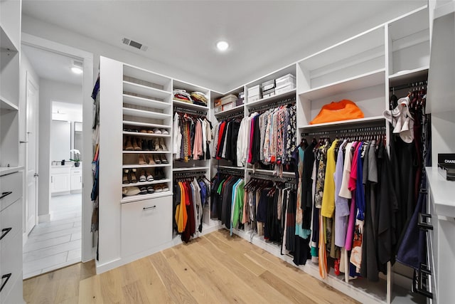 walk in closet featuring light wood-style flooring and visible vents