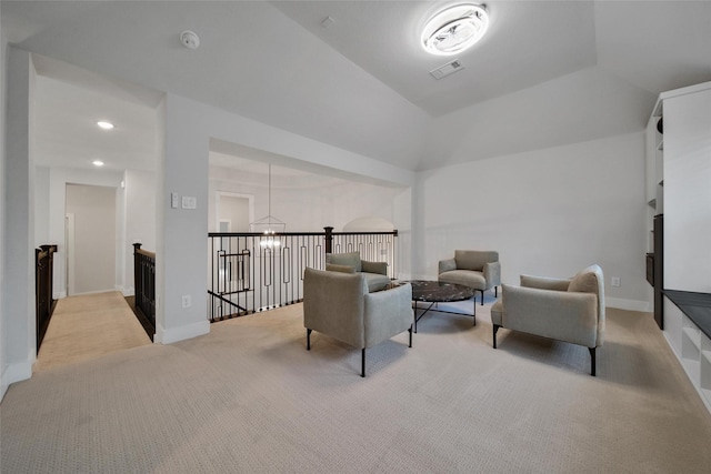living area featuring visible vents, carpet, a chandelier, and an upstairs landing