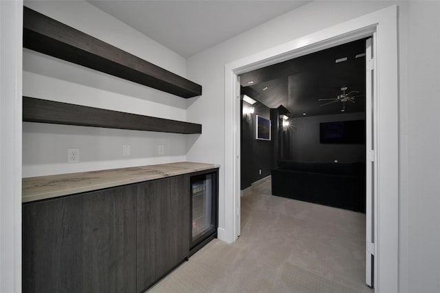 bar featuring light carpet and a ceiling fan