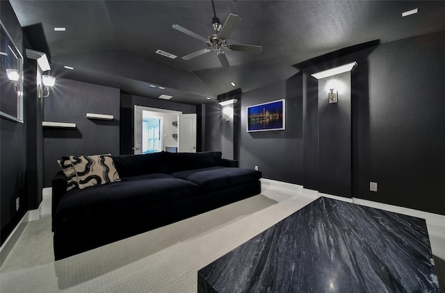 cinema with baseboards, visible vents, a ceiling fan, and lofted ceiling