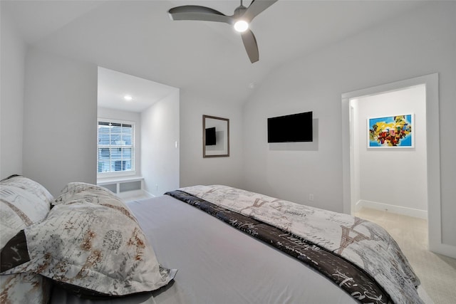 bedroom with light colored carpet, a ceiling fan, baseboards, and vaulted ceiling
