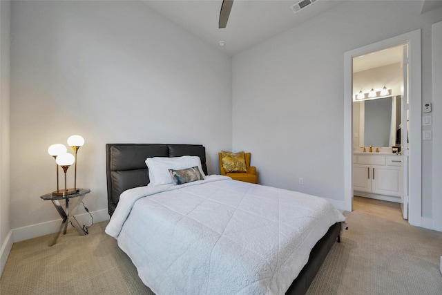 bedroom featuring baseboards, light carpet, connected bathroom, and visible vents
