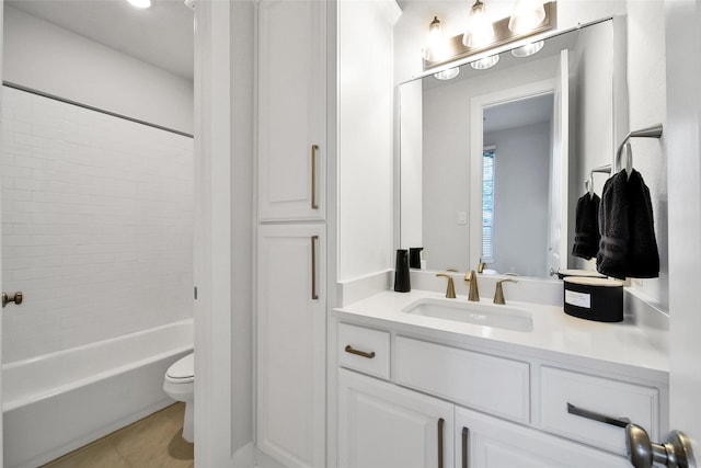 bathroom with vanity, tile patterned flooring, toilet, and shower / washtub combination