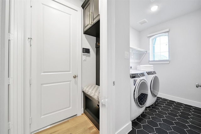 laundry room with baseboards, laundry area, and washer and clothes dryer
