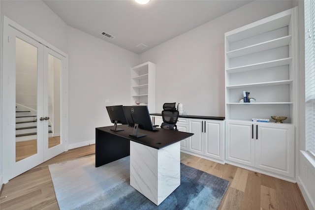 home office featuring french doors, visible vents, and light wood-style flooring