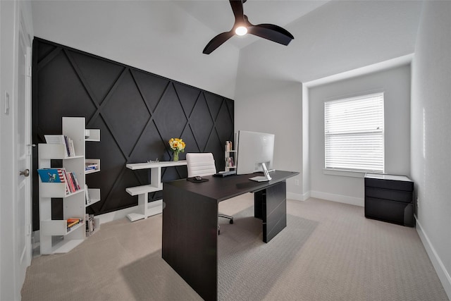 office featuring baseboards, a ceiling fan, and light carpet