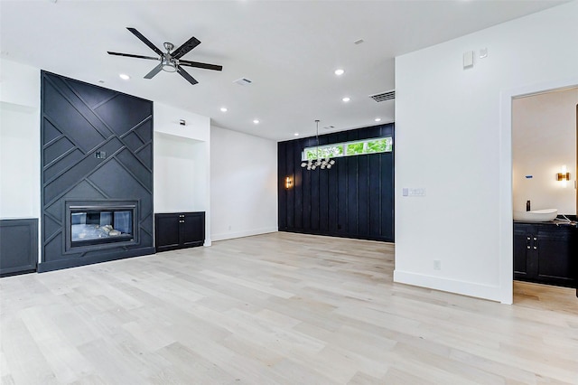 1907 Lauderdale St, Houston, TX 77030 - unfurnished living room with a ceiling fan, light wood-style flooring, baseboards, and a sink