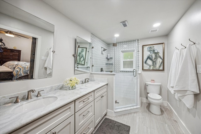 ensuite bathroom with visible vents, a sink, and toilet