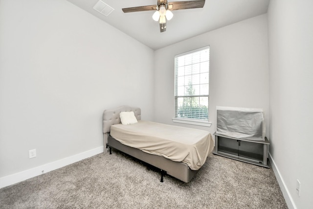 carpeted bedroom featuring ceiling fan, baseboards, and visible vents