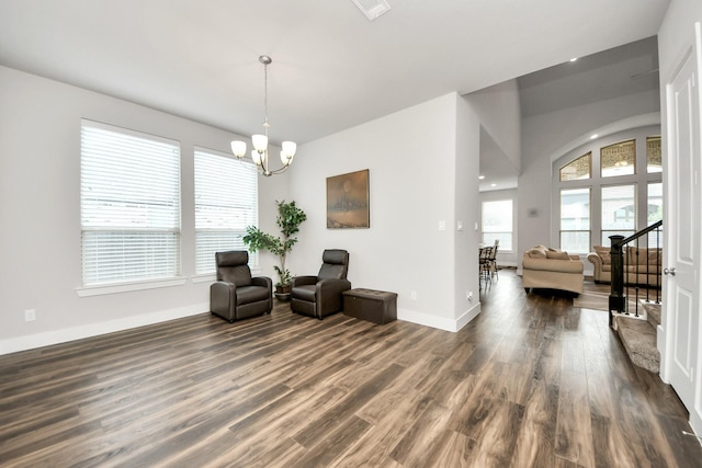 sitting room featuring baseboards, a notable chandelier, and dark wood finished floors