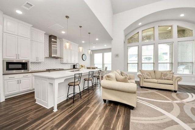 living room featuring visible vents, recessed lighting, and dark wood-style floors