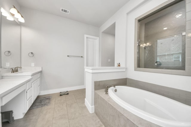 full bath featuring a tile shower, baseboards, visible vents, a garden tub, and vanity