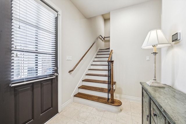 stairway featuring baseboards