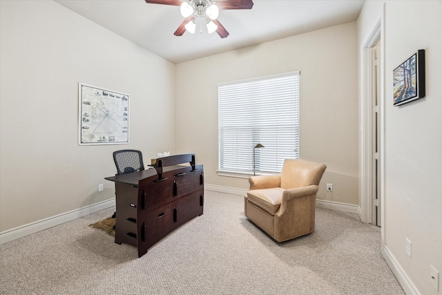 carpeted home office featuring baseboards and a ceiling fan