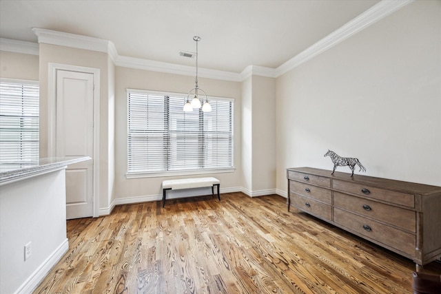 dining space featuring crown molding, baseboards, and wood finished floors
