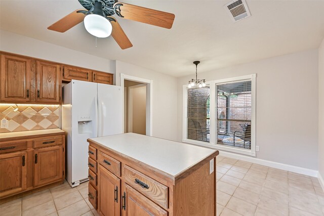 kitchen featuring tasteful backsplash, visible vents, brown cabinets, white fridge with ice dispenser, and light tile patterned floors