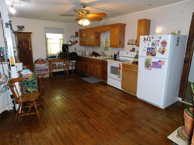 kitchen featuring a sink, brown cabinets, white appliances, light countertops, and dark wood-type flooring