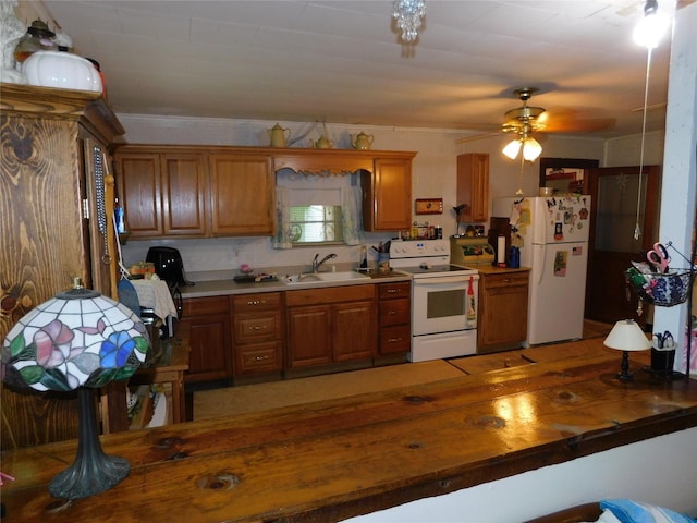 kitchen featuring brown cabinets, ceiling fan, a sink, and white appliances