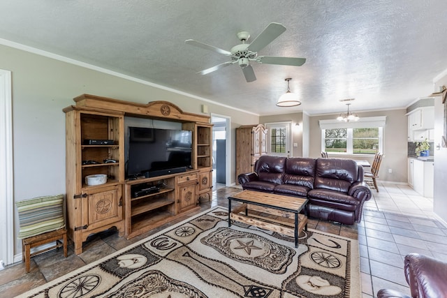 living area with ceiling fan with notable chandelier, baseboards, a textured ceiling, and crown molding