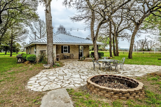 view of patio featuring a fire pit and a grill