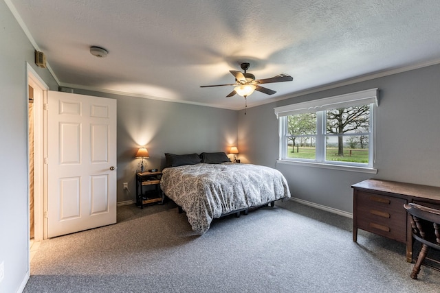 carpeted bedroom featuring a ceiling fan, baseboards, and crown molding