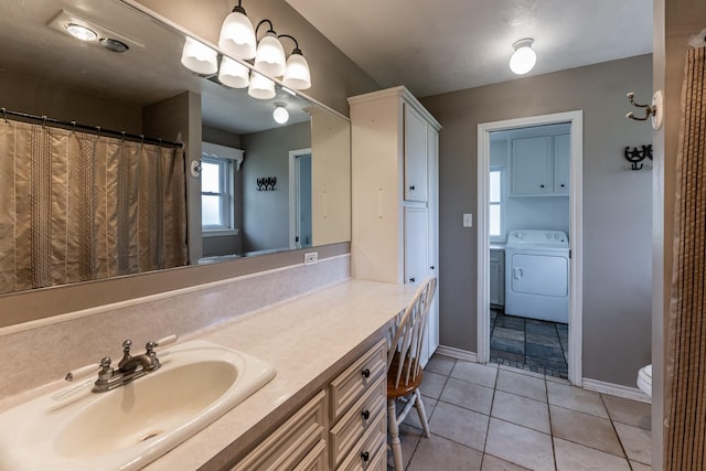 full bath featuring tile patterned flooring, toilet, vanity, baseboards, and washer and dryer