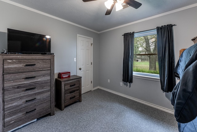 carpeted bedroom with ceiling fan, baseboards, a textured ceiling, and ornamental molding