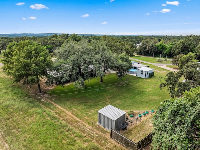 birds eye view of property featuring a wooded view and a rural view