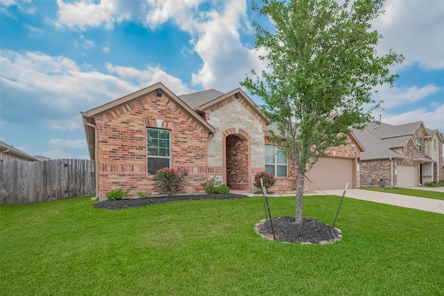 view of front of home with concrete driveway, brick siding, fence, and a front yard