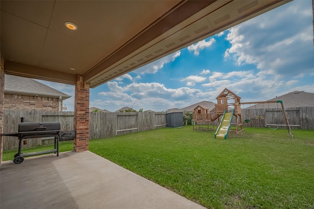 view of yard featuring a fenced backyard, a patio, and a playground