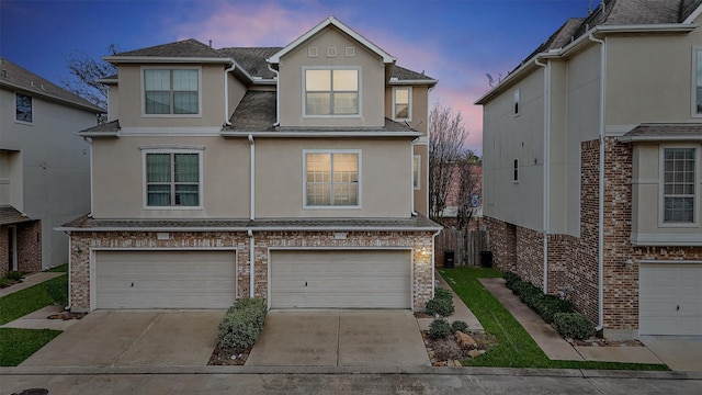 7818 Stoneyway Dr, Houston, TX 77040 - townhome / multi-family property with brick siding, driveway, stucco siding, and a garage