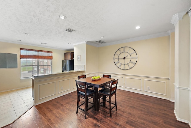 7818 Stoneyway Dr, Houston, TX 77040 - dining room featuring wainscoting, crown molding, dark wood-type flooring, and recessed lighting