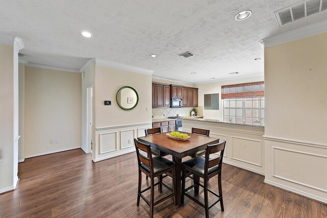 7818 Stoneyway Dr, Houston, TX 77040 - dining area with crown molding, dark wood-type flooring, and visible vents