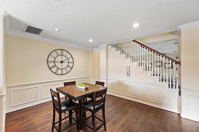 7818 Stoneyway Dr, Houston, TX 77040 - dining space featuring a decorative wall, wood finished floors, visible vents, and ornamental molding
