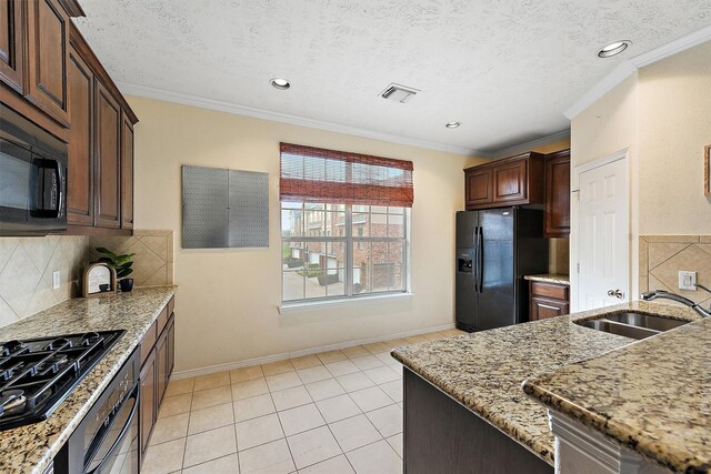 7818 Stoneyway Dr, Houston, TX 77040 - kitchen featuring a sink, visible vents, backsplash, light stone countertops, and black appliances