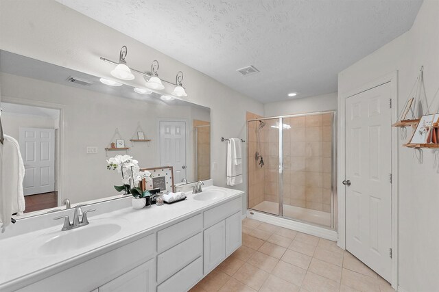 7818 Stoneyway Dr, Houston, TX 77040 - bathroom with a shower stall, tile patterned floors, a sink, and visible vents
