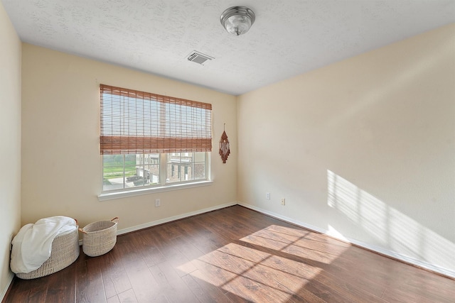 7818 Stoneyway Dr, Houston, TX 77040 - spare room with baseboards, wood finished floors, visible vents, and a textured ceiling