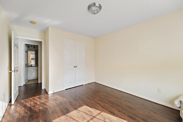7818 Stoneyway Dr, Houston, TX 77040 - unfurnished bedroom featuring baseboards, a closet, and dark wood-style flooring
