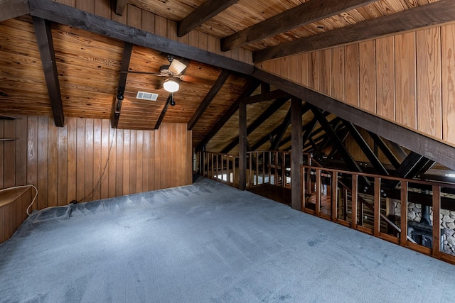 interior space with beamed ceiling, carpet, and wood ceiling